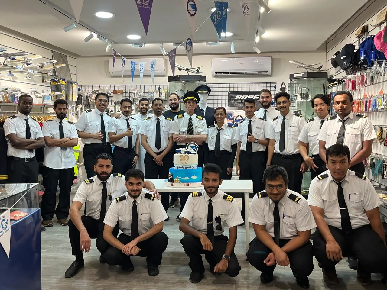 Students and instructors marking 20 years of Aviation Pioneers at the pilot shop