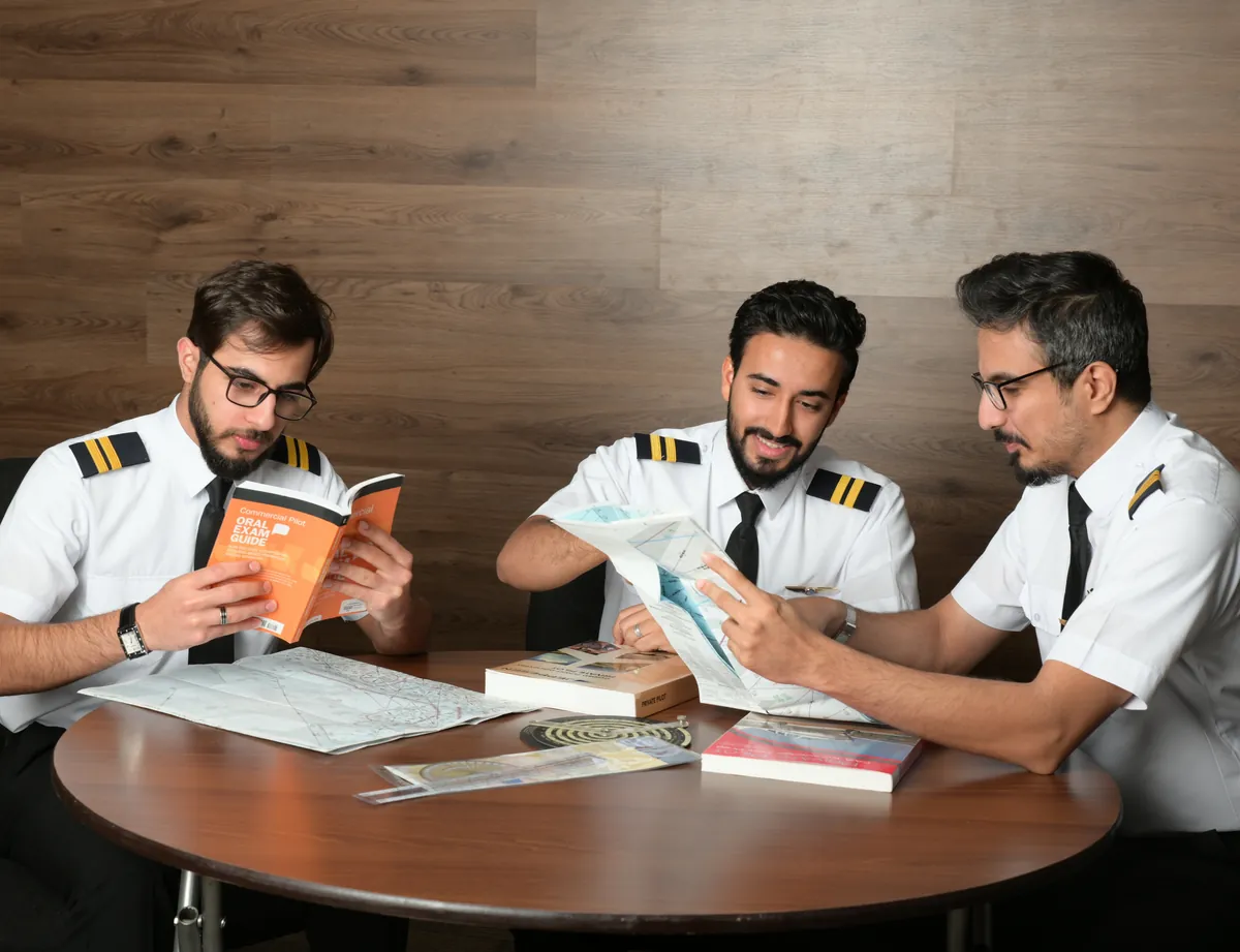 Students studying with exam guides and navigation charts