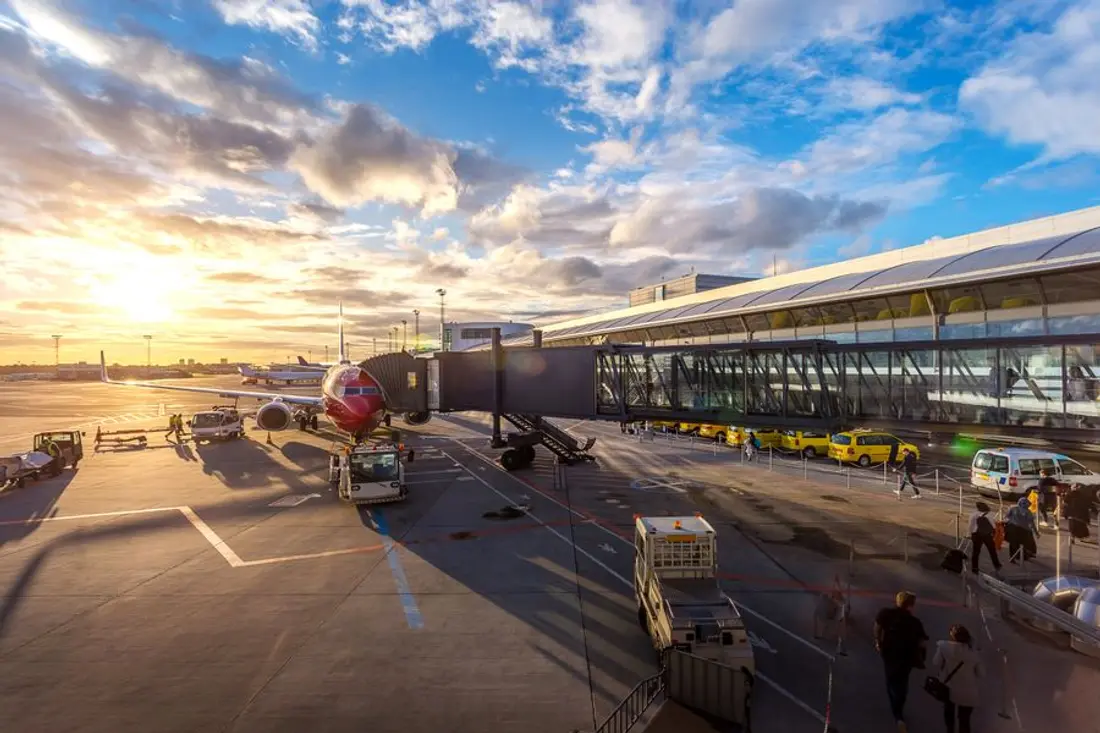 Airliner at the terminal gate at sunset